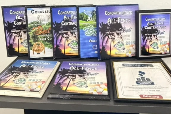 Row of Best of Cape Coral Fence and Gates plaques and a BBB accreditation certificate won by All Fence Contractors